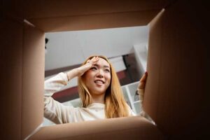 Young woman thinking over a box